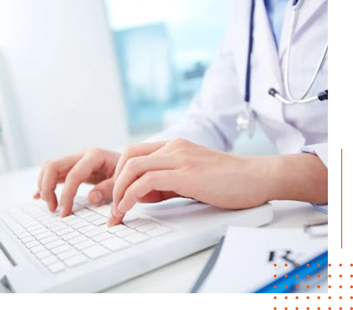 A person typing on a keyboard with stethoscope around neck.