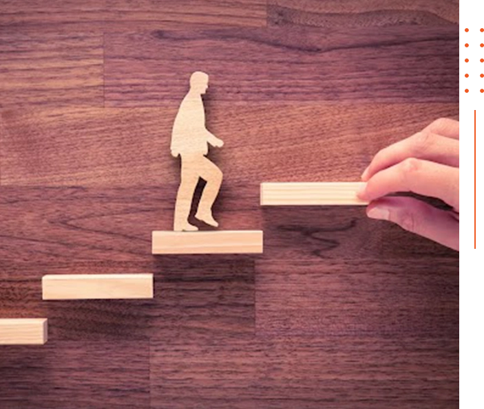 A person is walking up some stairs with a wooden figure.